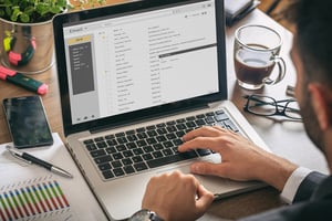 person looking at emails on laptop