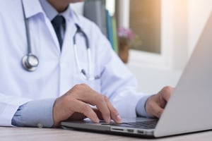 medical professional using a laptop