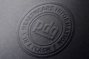 PDQ logo embossed on black paper