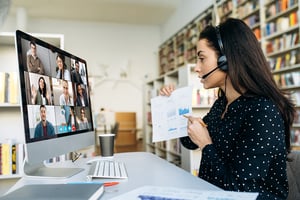 Online video conference. Computer monitor view with multiracial successful business colleagues, and businesswoman shows them a graph