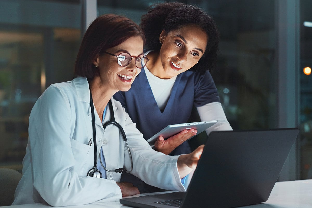 doctor and nurse looking at tablet together