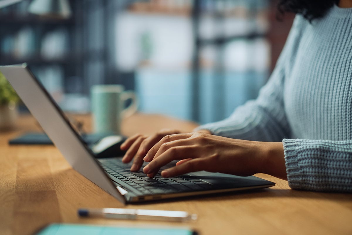 close up of person typing on a laptop